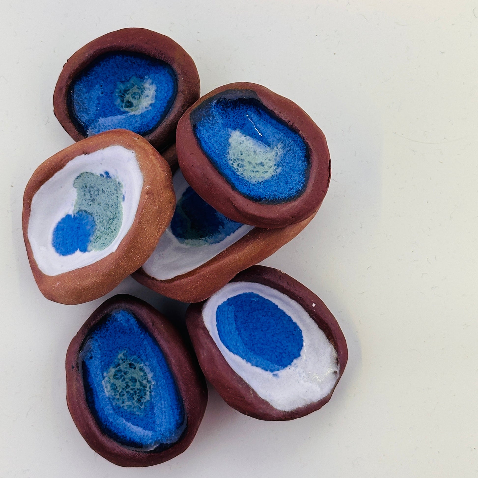 Decorative stones with blue and white centers on a white background