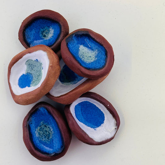 Decorative stones with blue and white centers on a white background